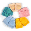 Colorful baby knee pads with smiley faces, suitable for infants and toddlers, providing non-slip crawling protection.