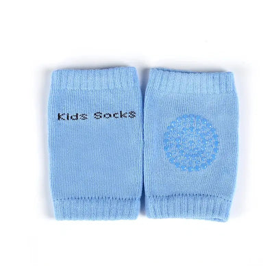 Light blue baby knee pads for kids with text 'Kids Socks' and a circular design, perfect for crawling and safety.