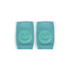 Turquoise baby knee pads with smiley face design for infants and toddlers, non-slip crawling cushion.