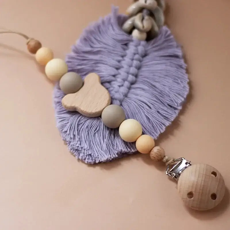 Custom wooden baby pacifier chain with silicone beads and a clip, ideal newborn gift and teether accessory.