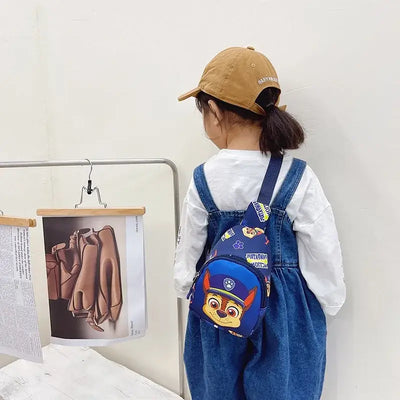 Child wearing Paw Patrol mini shoulder bag, showcasing cartoon design, perfect for boys and girls outdoor adventures.