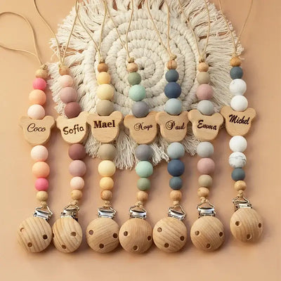 Personalized wooden pacifier chain with colorful silicone beads, custom names for newborns, and teething safety.