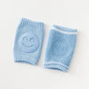 Blue baby knee pads with smiley face design, non-slip crawling cushions for infants and toddlers.