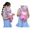 Girl carrying a doll in a pink and purple baby carrier, showcasing the doll accessory for 15-18 inch dolls.