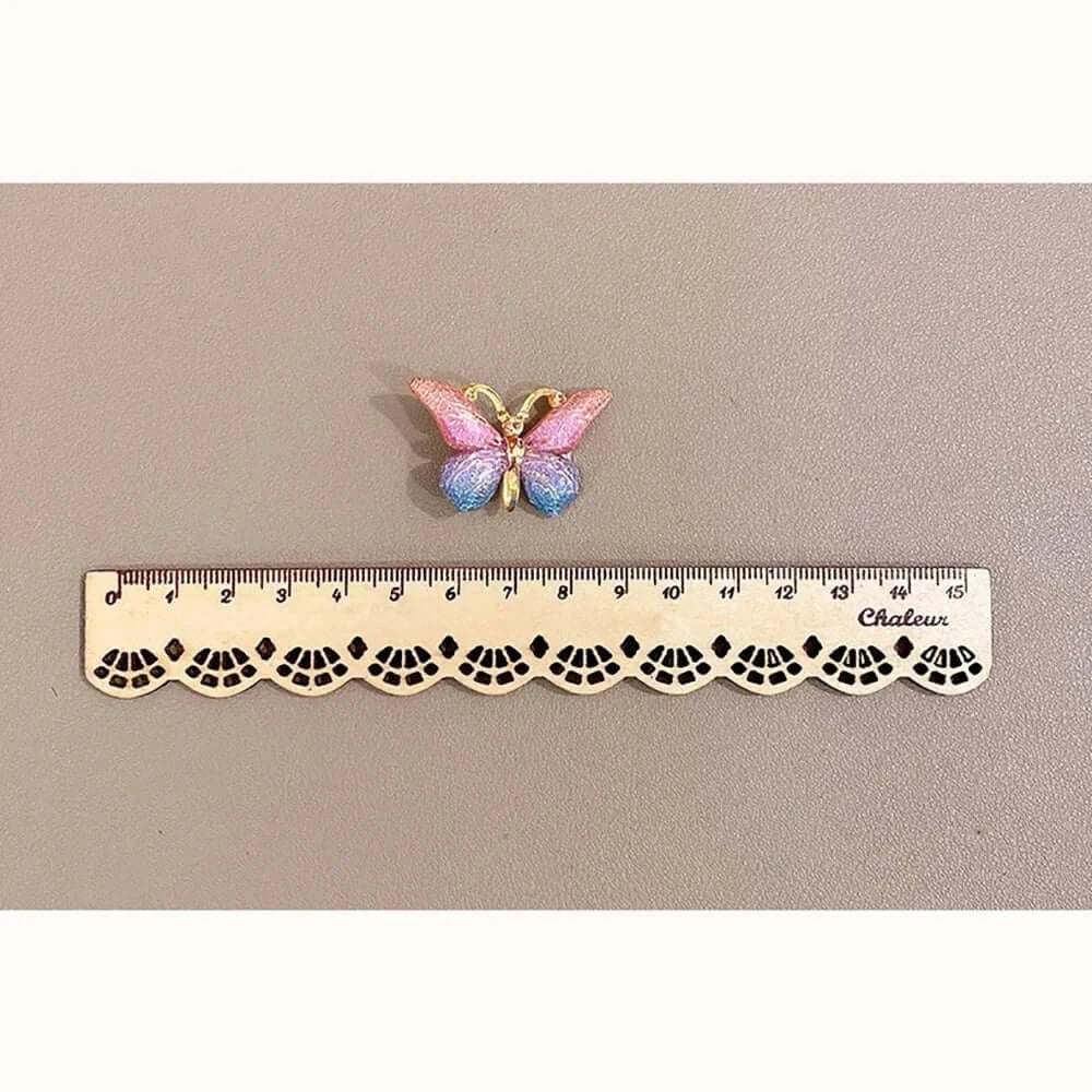Colorful butterfly hairpin displayed above a ruler for size reference, showcasing a cute accessory for girls.