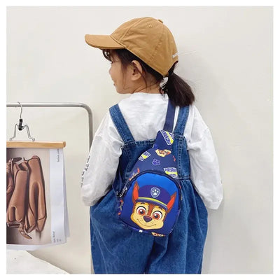 Cute kid wearing Paw Patrol mini shoulder bag featuring cartoon character design, perfect for outdoor adventures.