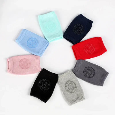 Assorted baby knee pads in various colors arranged in a circle, featuring non-slip designs for infants and toddlers.