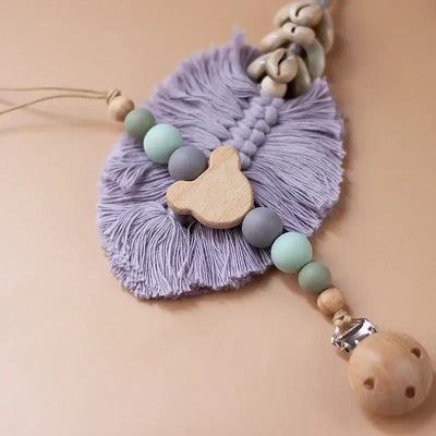 Personalized baby pacifier chain featuring wooden and silicone beads, teether pendant in soft lavender tones.